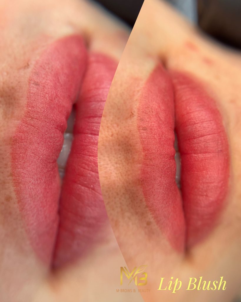 M Brows and Beauty Close-up of lips with a pinkish-red tint, showing the results of a lip blush cosmetic treatment. The lips appear smooth and evenly coloured. “MB M-Brows & Beauty” and “Lip Blush” are written in the corner.